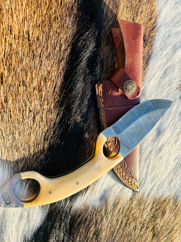 Knife and sheath displayed on camping gear setup